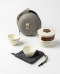Tea-making set with bowls, a pot, and carrying case on a white background